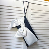 Navy blue and ivory satin handbag for wedding guest outfit