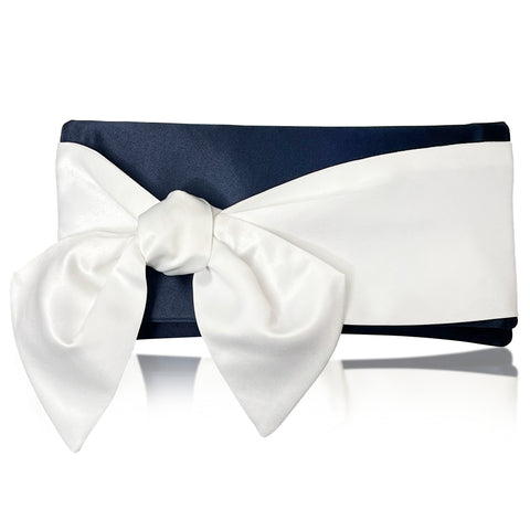 A navy clutch evening with ivory bow detail