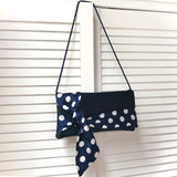 Navy and white polka dot satin clutch handbag PIPER